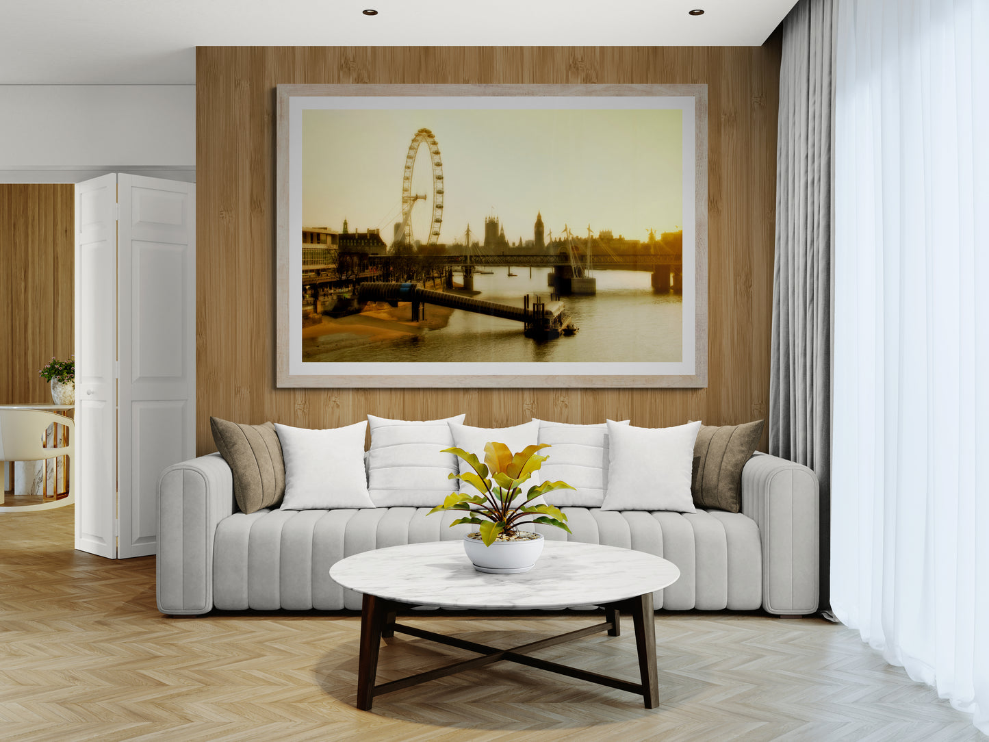 Modern living room with a gray sofa, white coffee table, and framed picture of the London eye