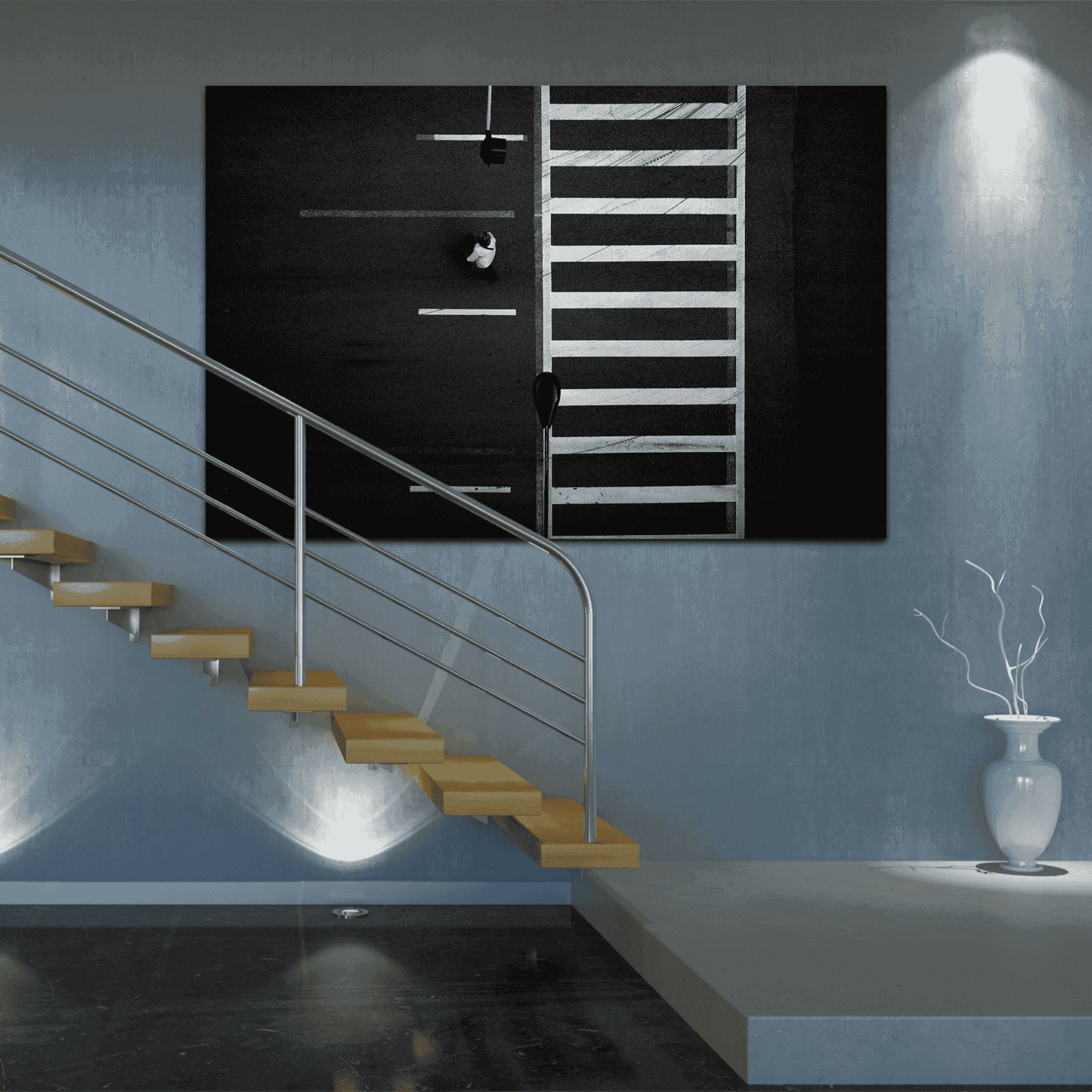 Overhead black and white photograph of Chicago crosswalk with pedestrian and graphic street pattern on wall of modern residential staircase