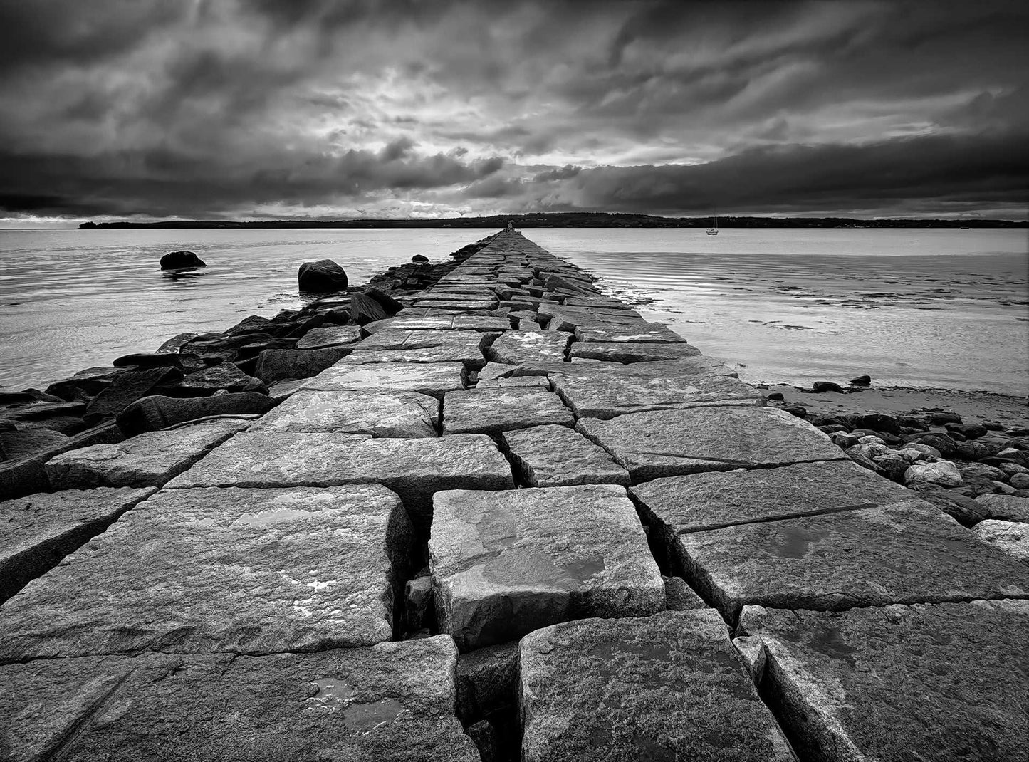 A black and white photograph of Rockland Breakwater, Maine—serene, moody, and unexpectedly unforgettable. Selected for national exhibition in 2024 at The International Photography Hall of Fame and Museum