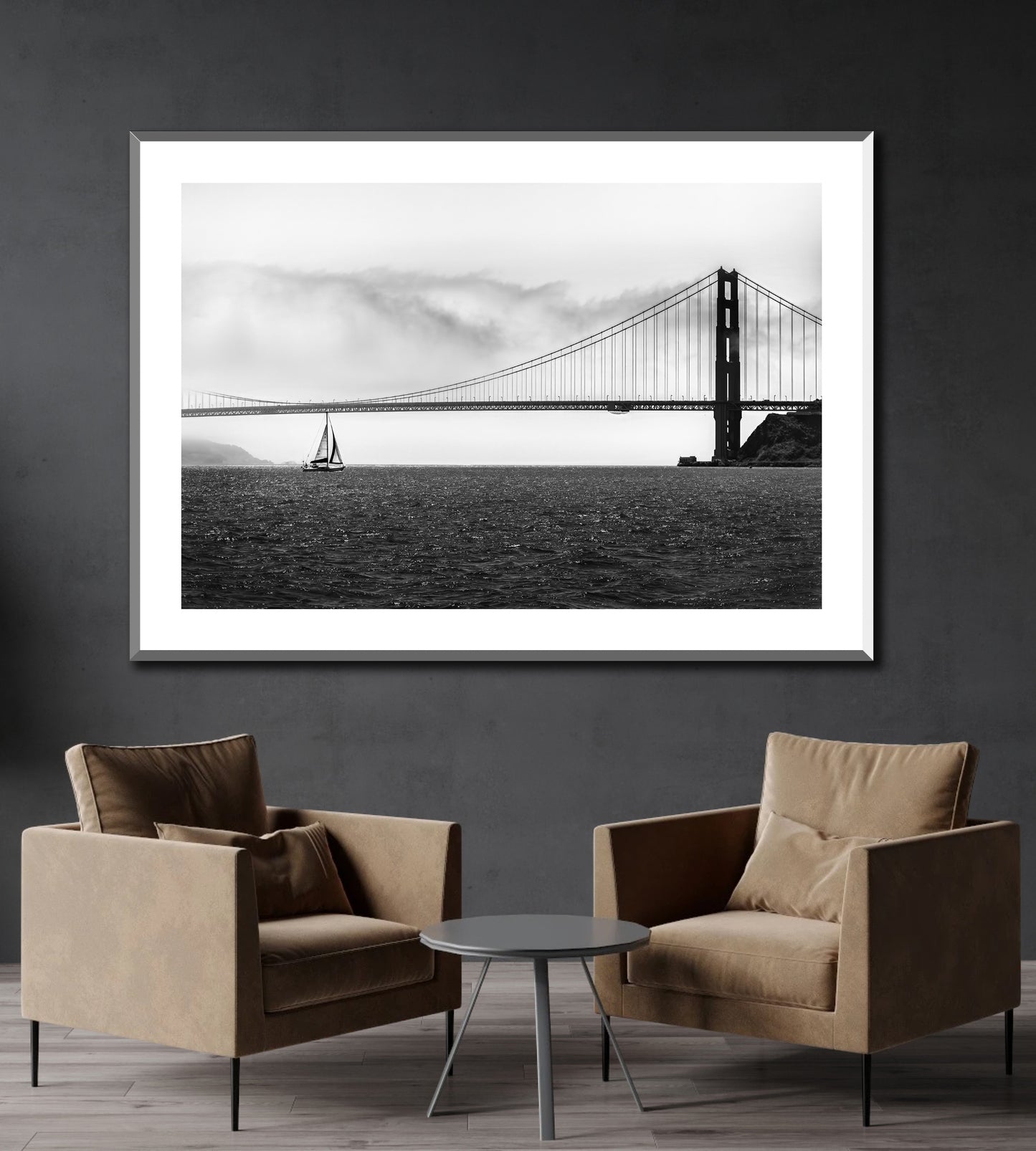 Black and white photo of Golden Gate Bridge with sailboat on the wall of a reception area.
