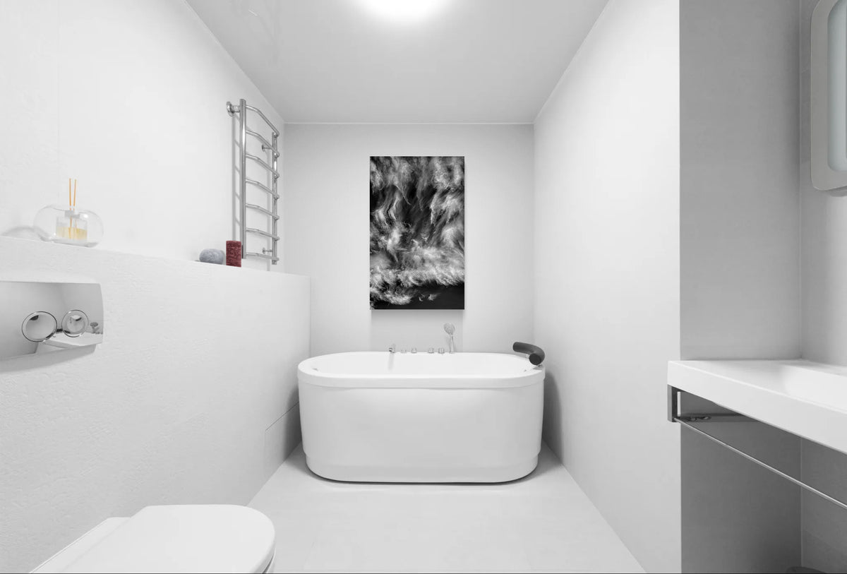  Black and white fine art photograph of swirling cirrus clouds and a crescent moon displayed above a freestanding bathtub in a minimalist contemporary bathroom.