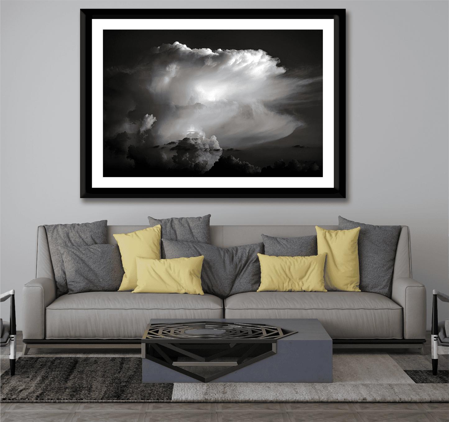 Thunderhead, Magnolia TX – Dynamic Texas Clouds in Black and White framed print above a beige and gray couch with yellow pillows in a cozy living room.