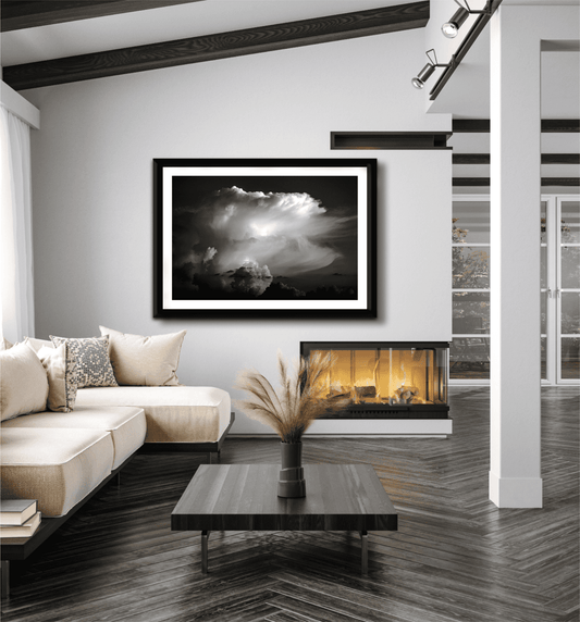 Thunderhead, Magnolia TX – Dynamic Texas Clouds in Black and White framed wall art displayed in a modern living room with neutral tones and fireplace.