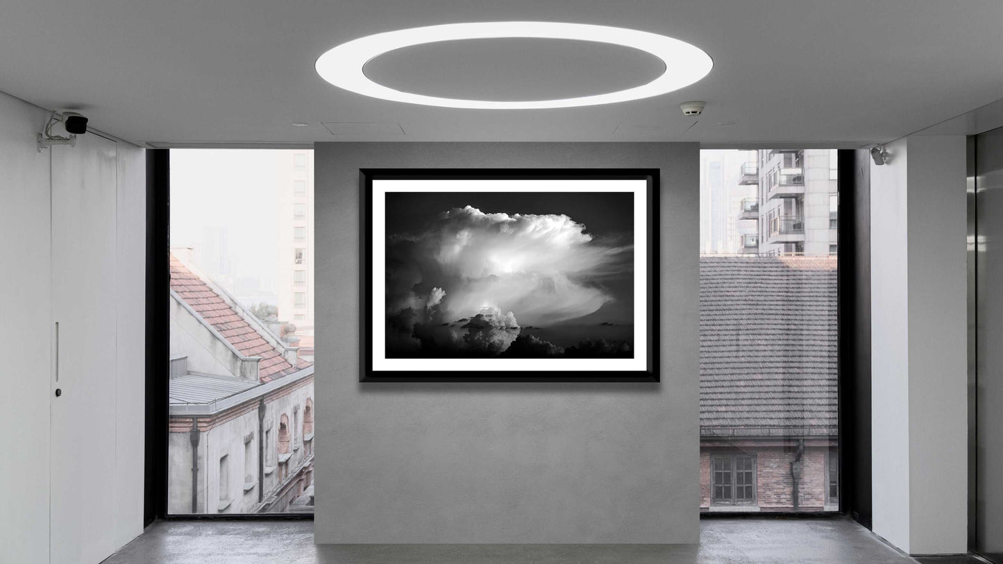 Thunderhead, Magnolia TX – Dynamic Texas Clouds in Black and White artwork showcased in a minimalist gallery with large windows and urban views.