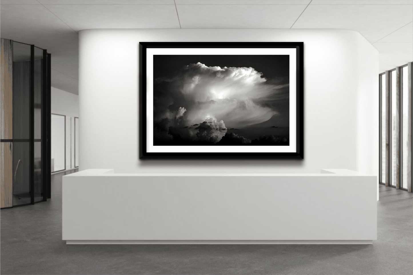 Thunderhead, Magnolia TX – Dynamic Texas Clouds in Black and White wall art displayed in a sleek office reception area with modern white decor.
