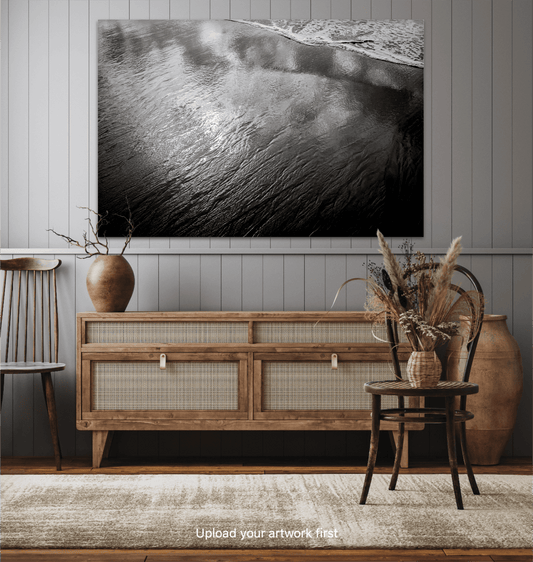 Black and white coastal artwork 'Traces #4 – Reflections at the Sea Edge, Maine' displayed in rustic home decor with wooden sideboard and neutral tones.
