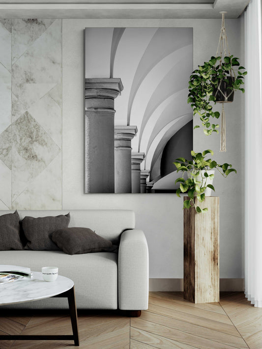 Arches, Barberino – Limited Edition Black and White Photograph of Italian Architecture displayed in a modern living room with neutral tones and indoor plants. Elegant vertical composition enhances the fine art appeal for interior design and wall decor.