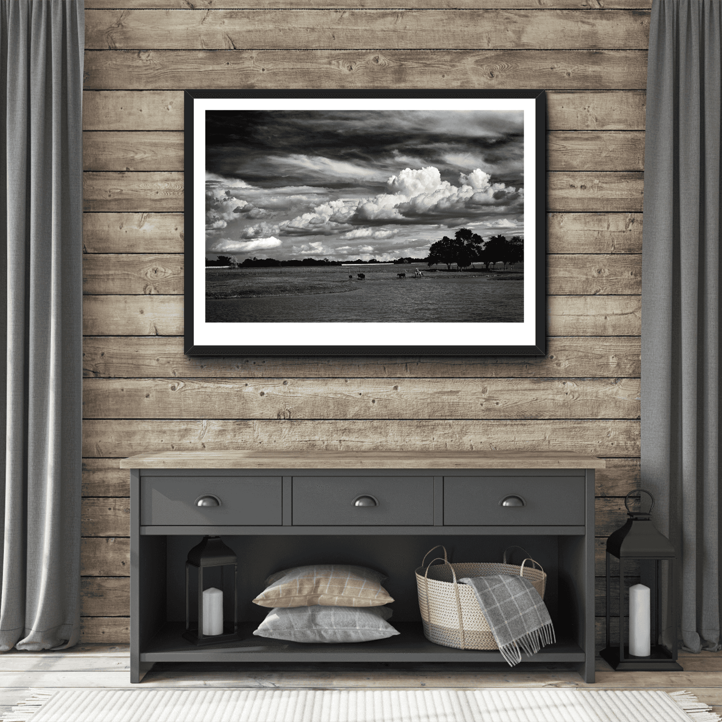 Framed Texas cowboy art 'Under a Texas Sky' on a wood-paneled wall above a rustic contemporary farmhouse console table with cozy home accents.