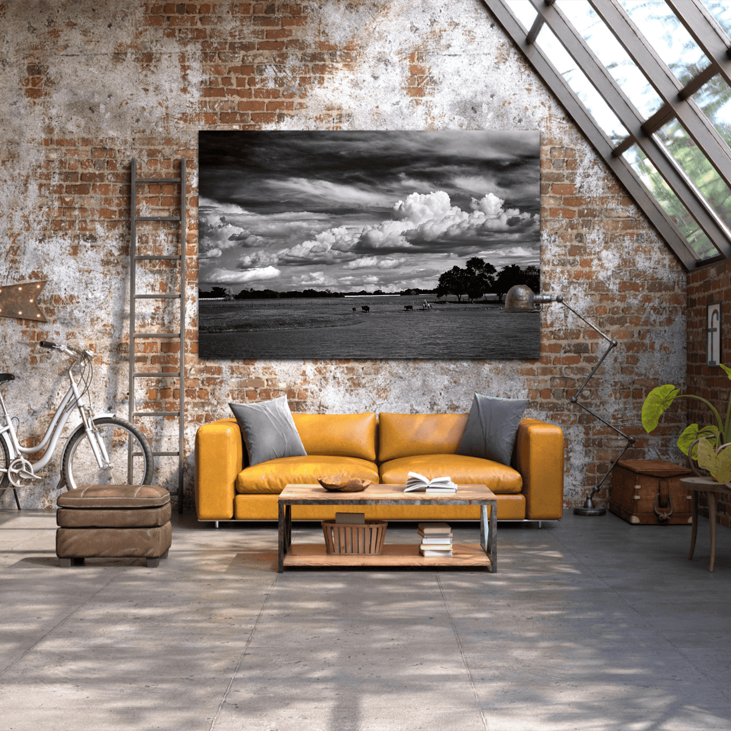 Large black and white cowboy print 'Under a Texas Sky' mounted above a yellow leather sofa in an industrial loft with rustic decor.