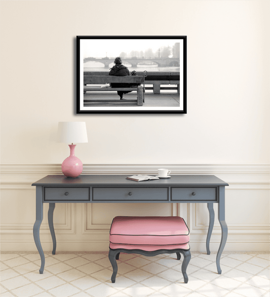 Zurich Series #6 – The Woman Overlooking the River Limmat framed black and white fine art print by Michael Hart displayed above a vintage desk in a soft-toned interior. Ideal for elegant home decor or art collectors.